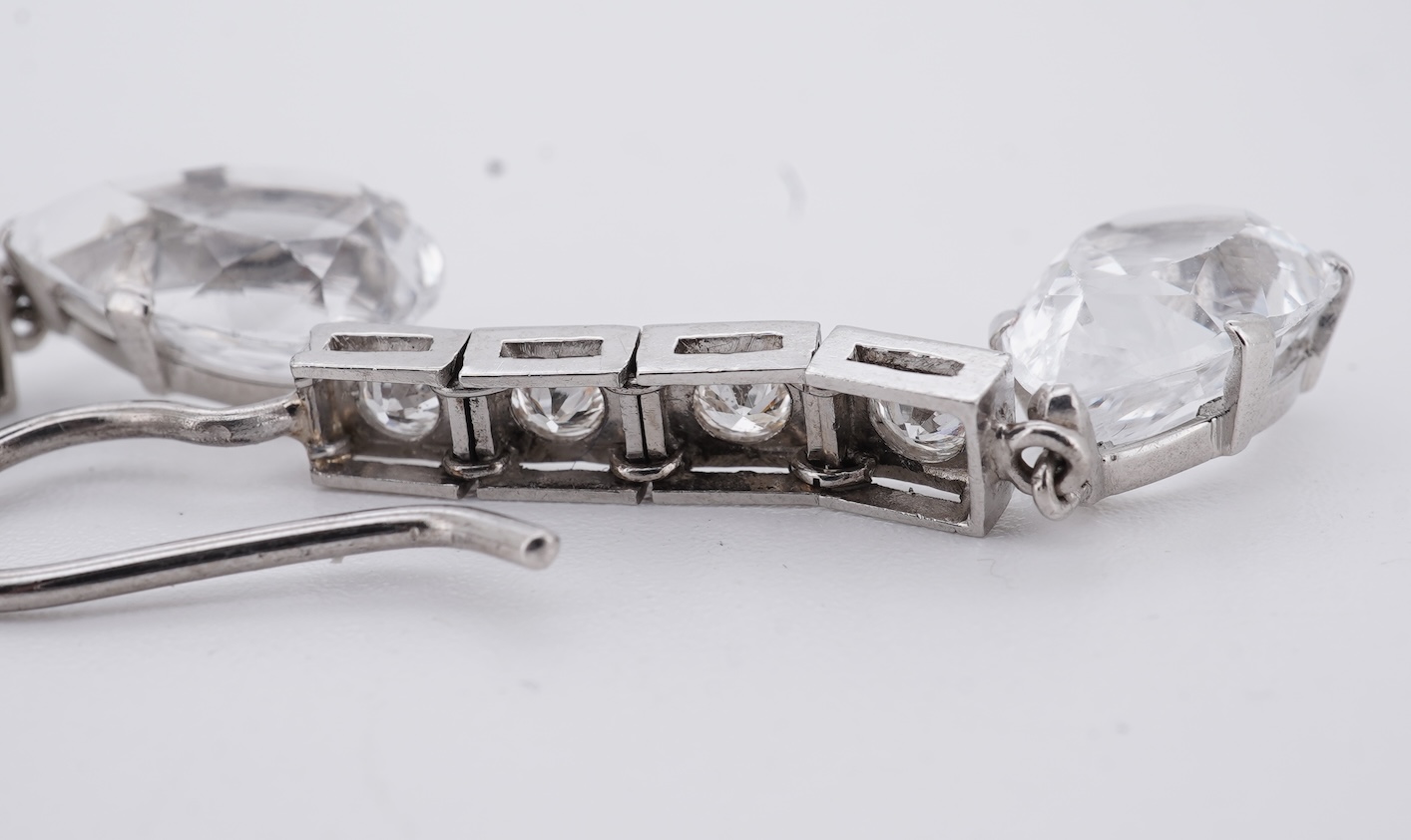 A pair of white metal and four stone diamond set earrings, each with a cubic zirconia pear shaped drop, overall 42mm.